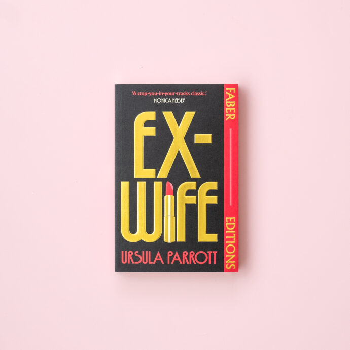 Ex-Wife paperback on a light pink background