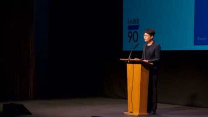 Poet Mary Jean Chan behind a lectern