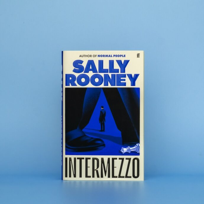 Hardback edition of Sally Rooney's novel Intermezzo on a blue background